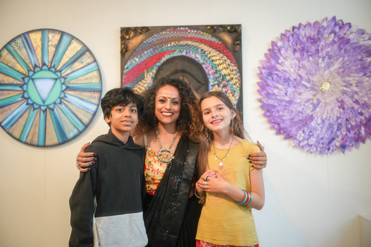 Artist with guests before her works at a Paris gallery opening — Vernissage